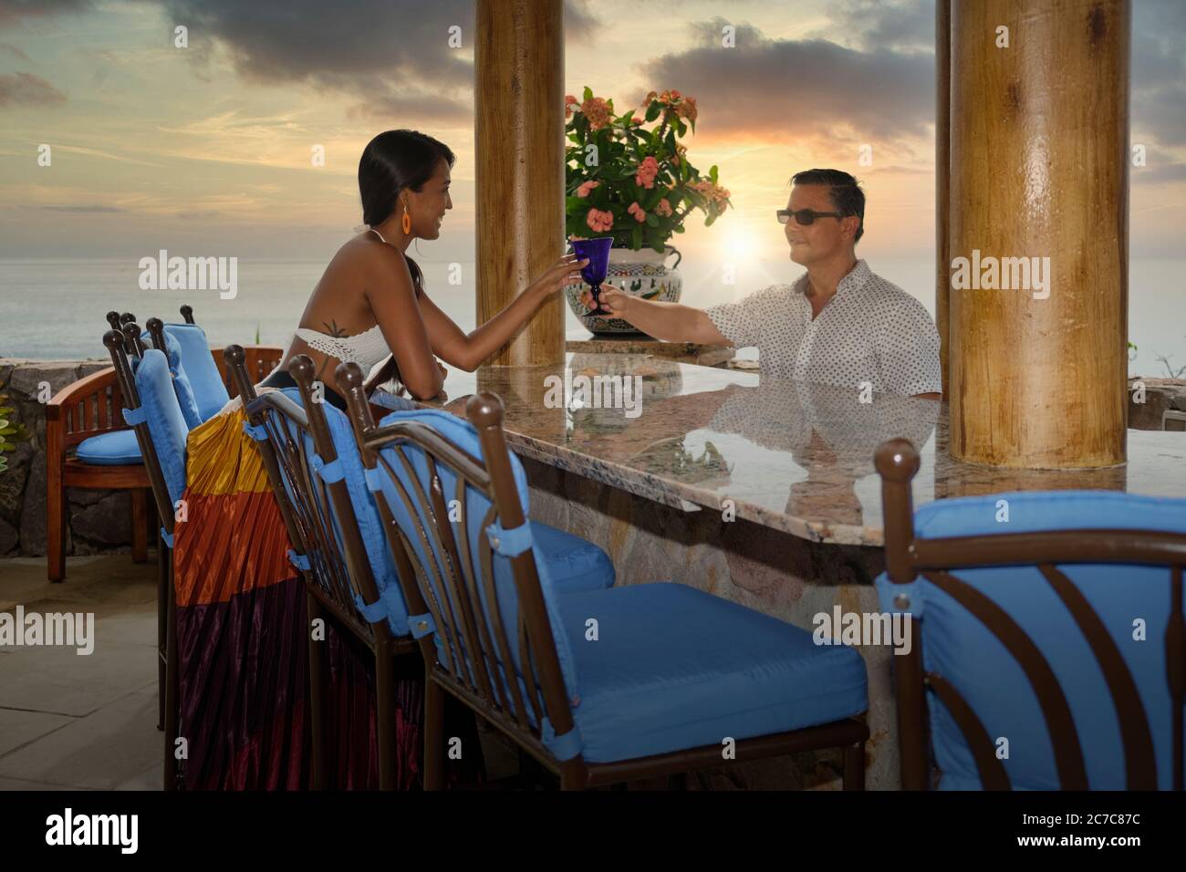 Vacation scene - woman receiving drink from barkeeper at an outdoor bar, Puerto Vallarta, Jalisco, Mexico Stock Photo