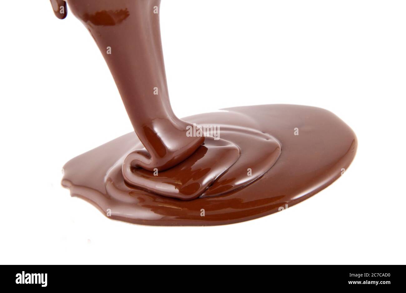 Chocolate flow isolated on white background close up Stock Photo