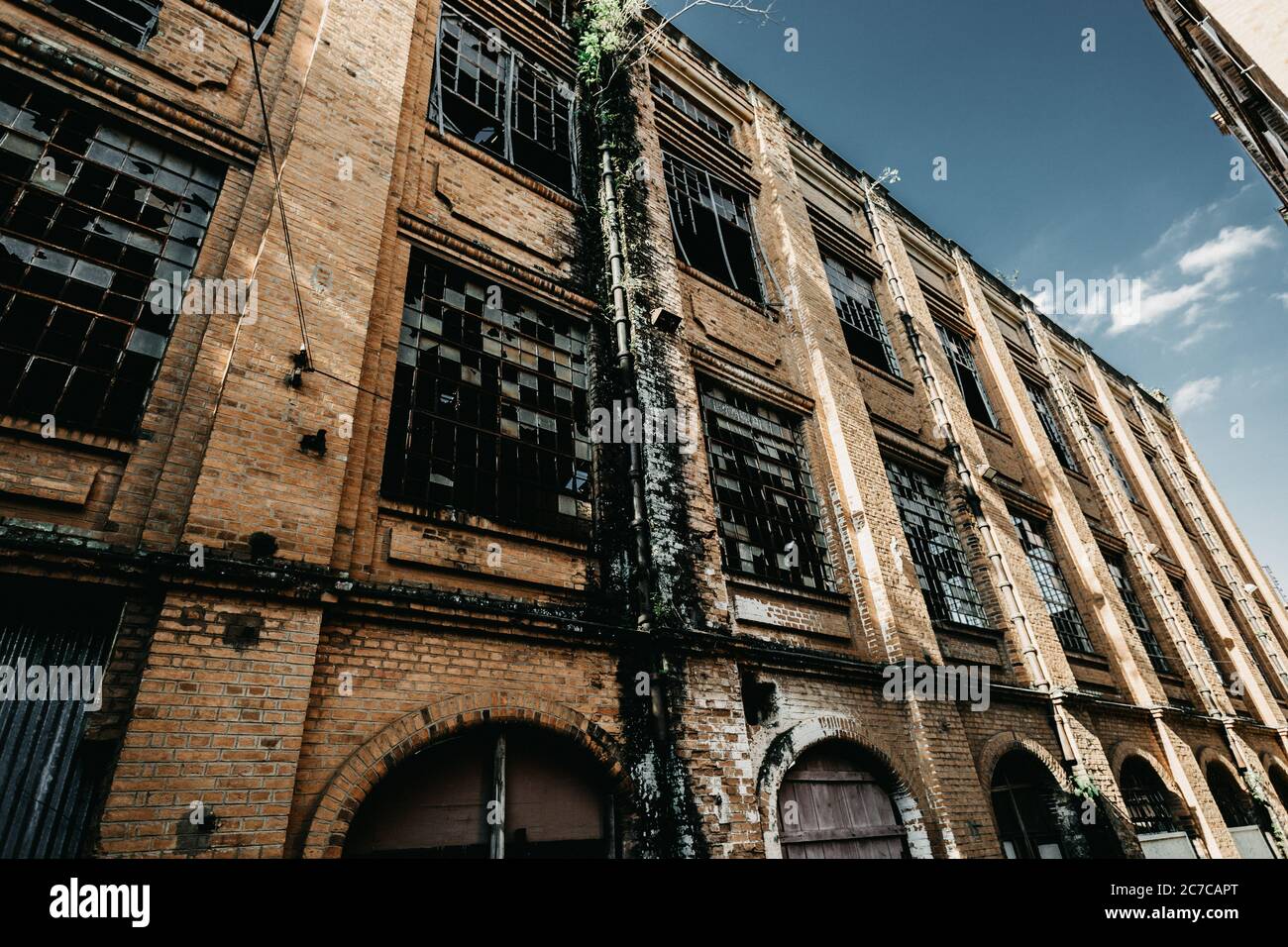 Low angle shot of an abandoned building wall with broken windows Stock ...