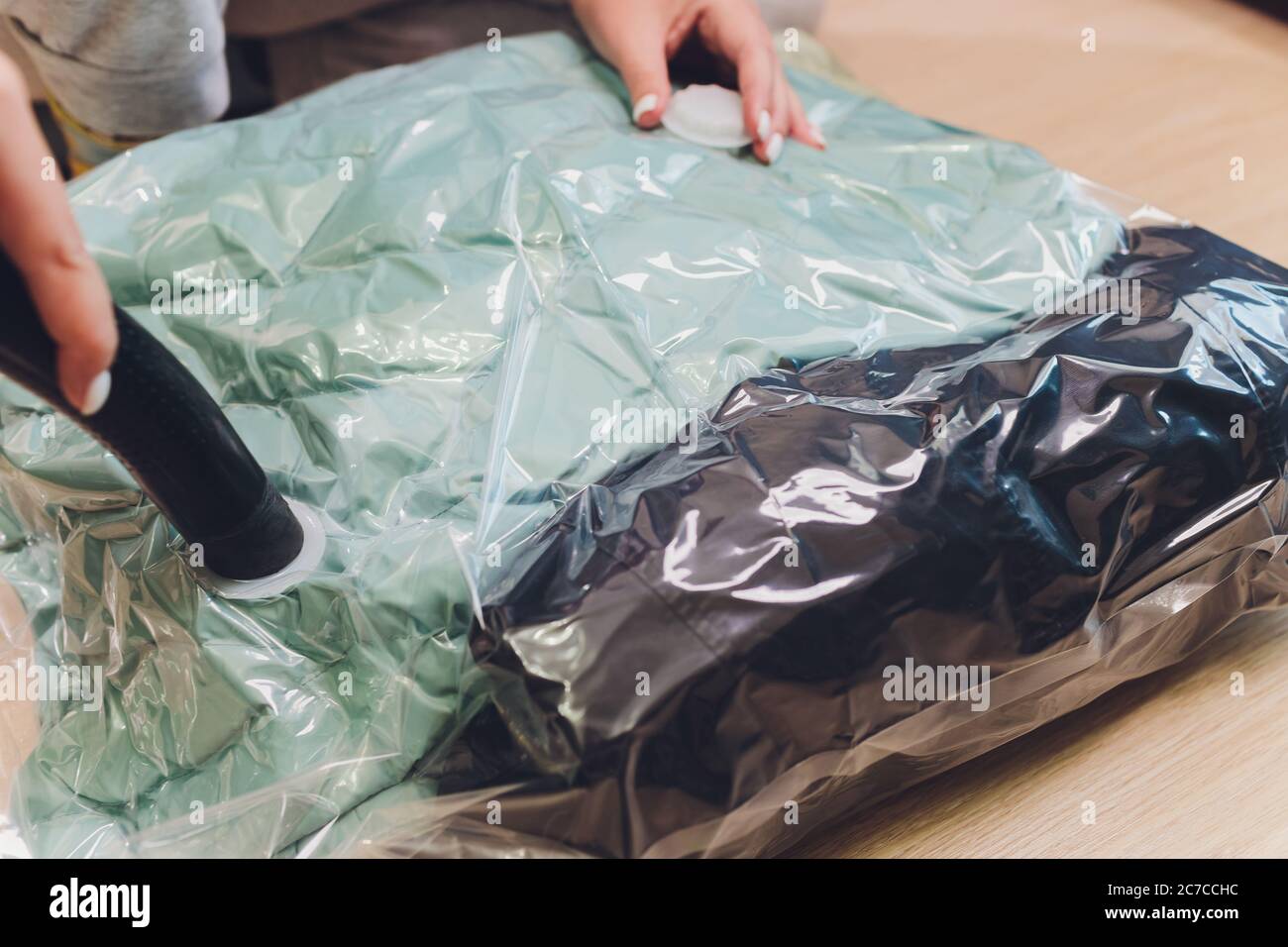 https://c8.alamy.com/comp/2C7CCHC/space-saver-saving-seal-bag-sucking-air-out-vacuum-clothing-storage-compressed-package-2C7CCHC.jpg