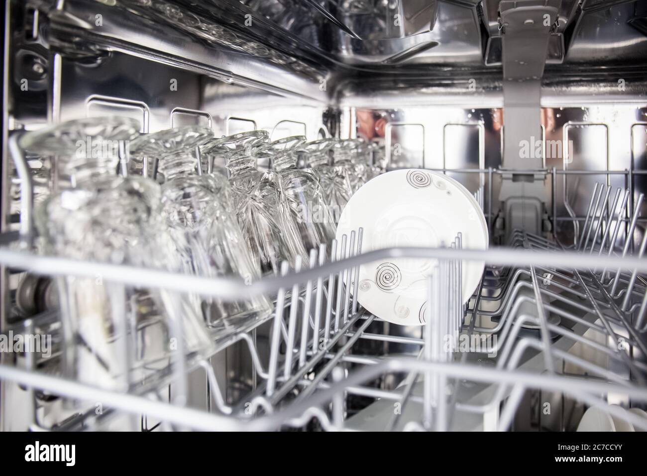 using dishwasher to save time in cleaning plates and glassware and routinely clean dirty dishes