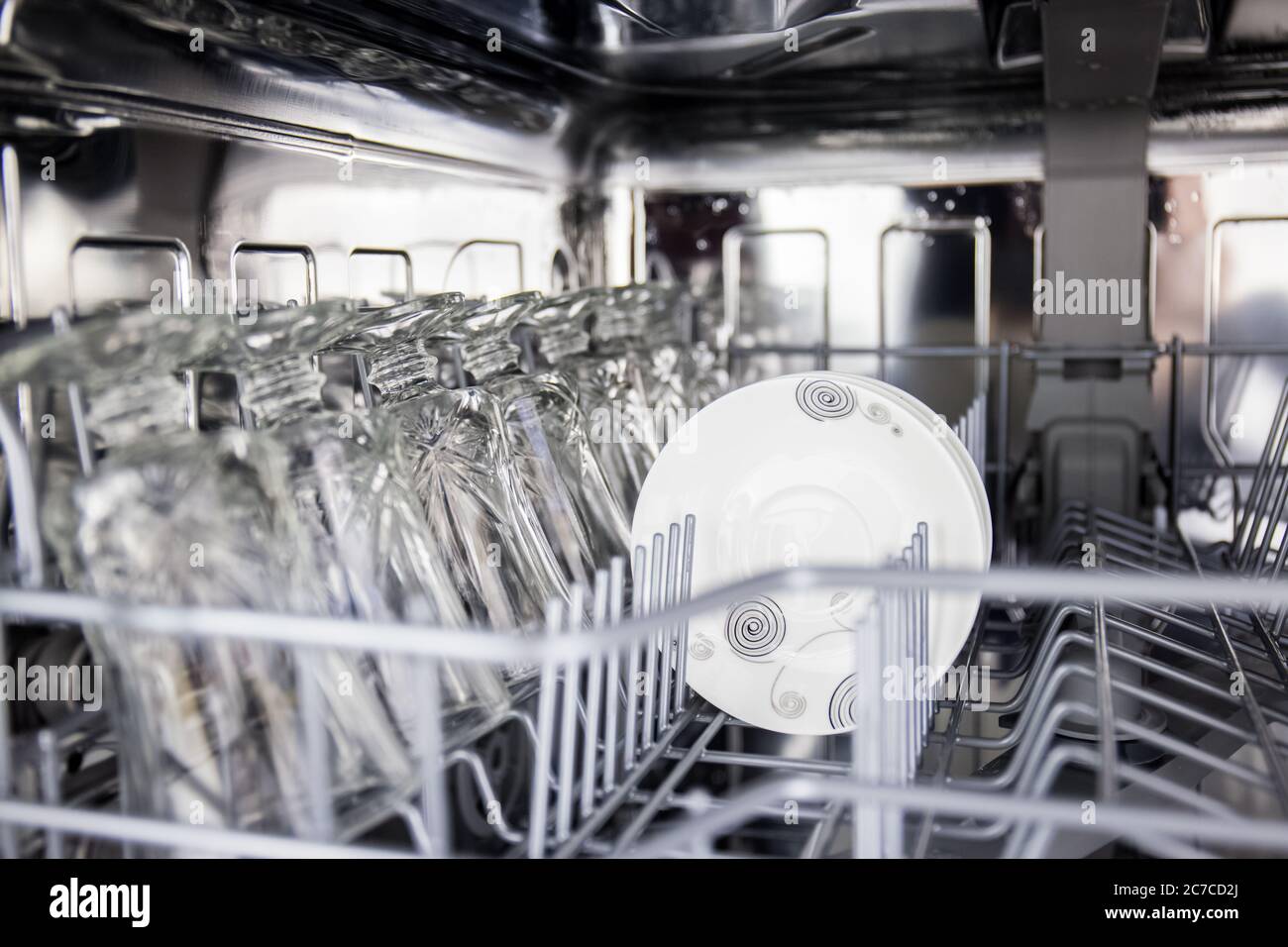 using dishwasher to save time in cleaning plates and glassware and  routinely clean dirty dishes for hygiene with technology to remove stains  Stock Photo - Alamy