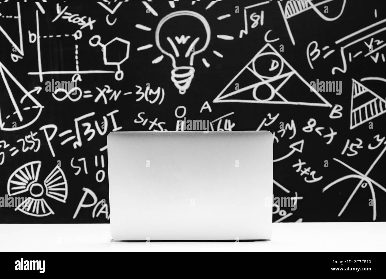 The chalk on the blackboard and laptops Stock Photo Alamy