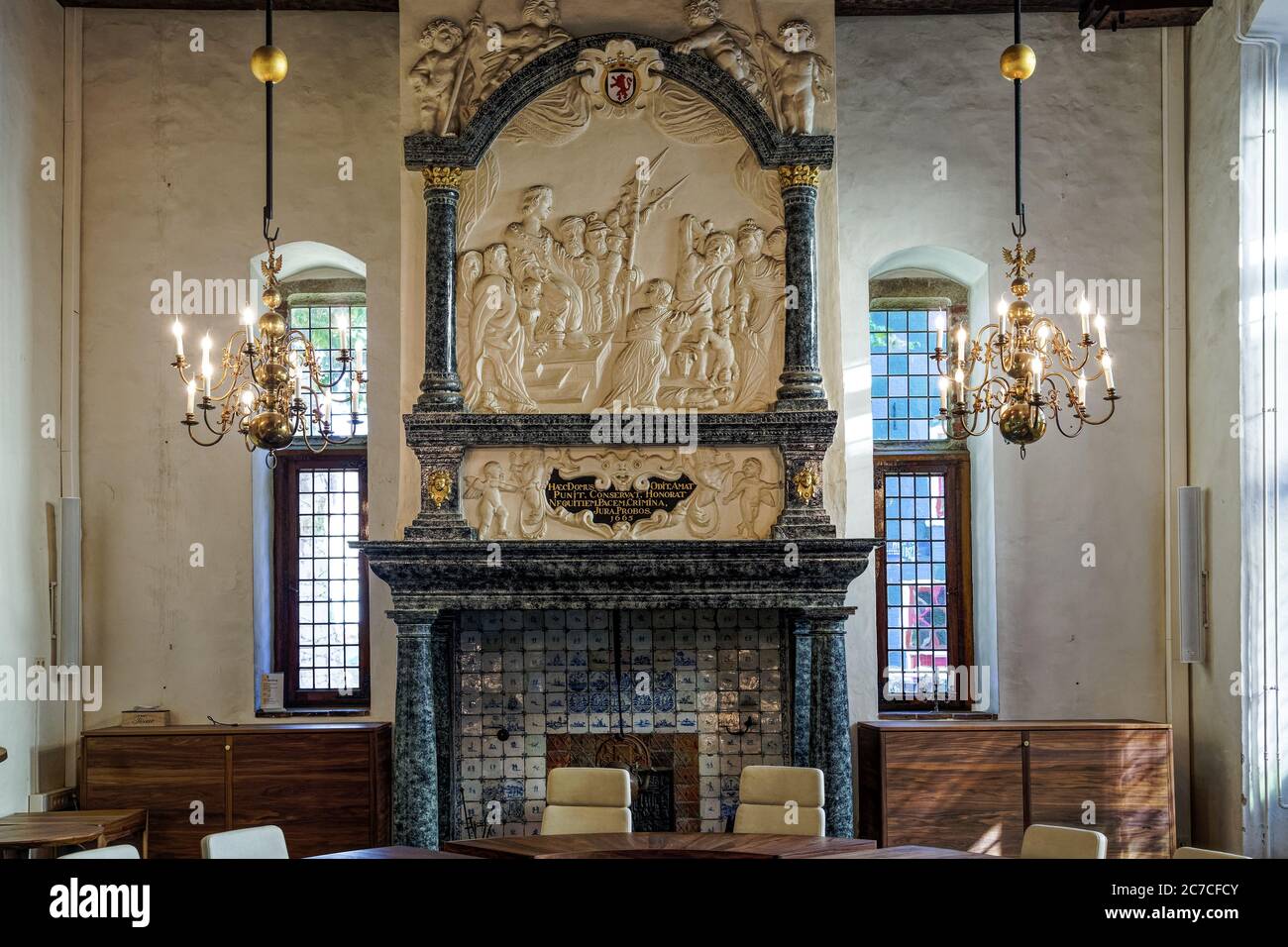 Interior shot of a fireplace in a Christian church decorated with bible scenes in the Netherlands Stock Photo