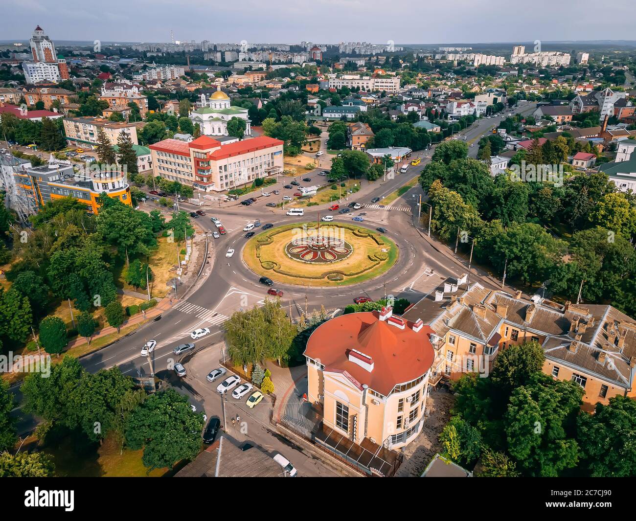 Aerial view of roundabout road with circular cars in small european city at summer afternoon, Kyiv region, Ukraine Stock Photo