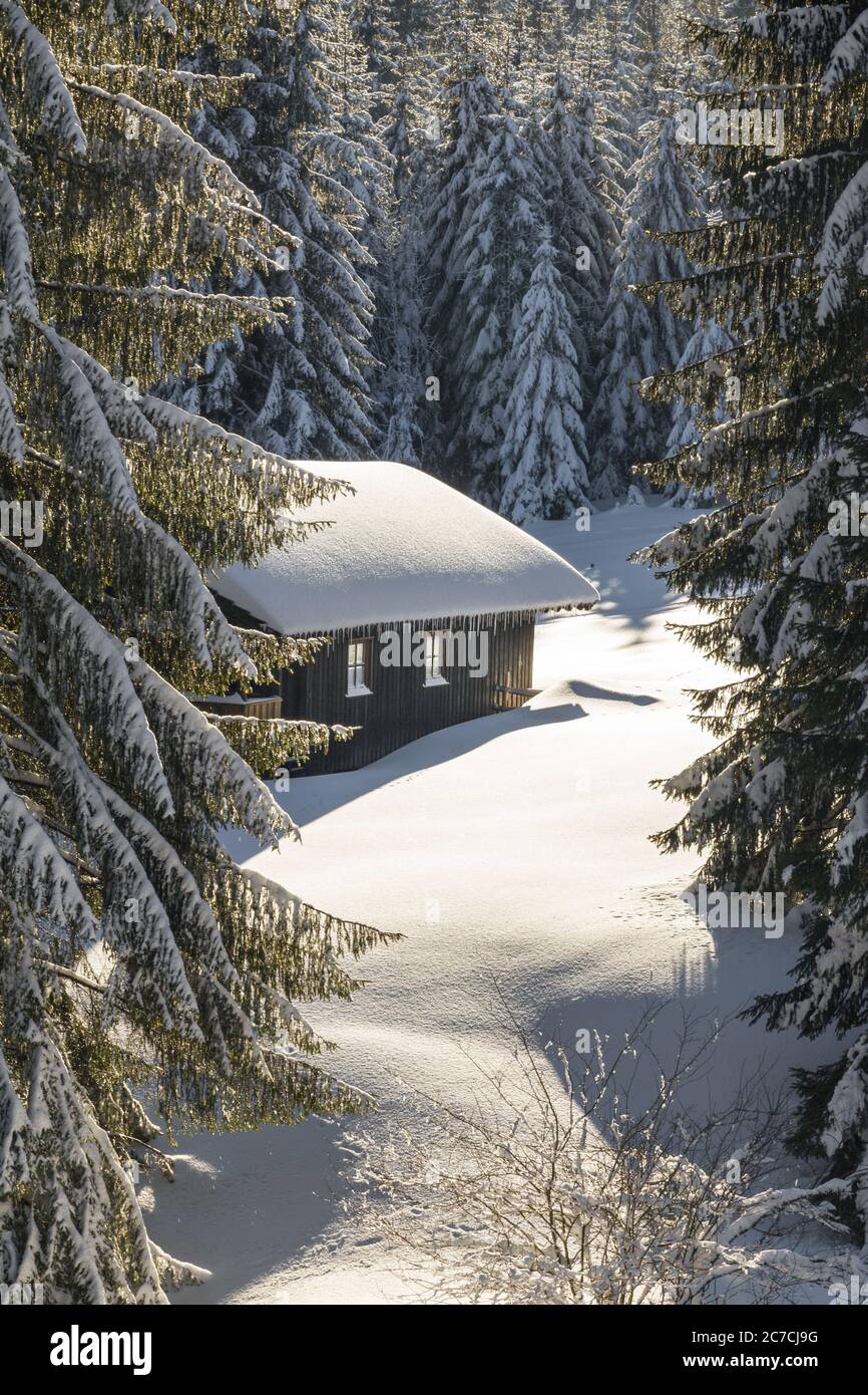 Old wooden snowy ski cabin in the Alps Stock Photo