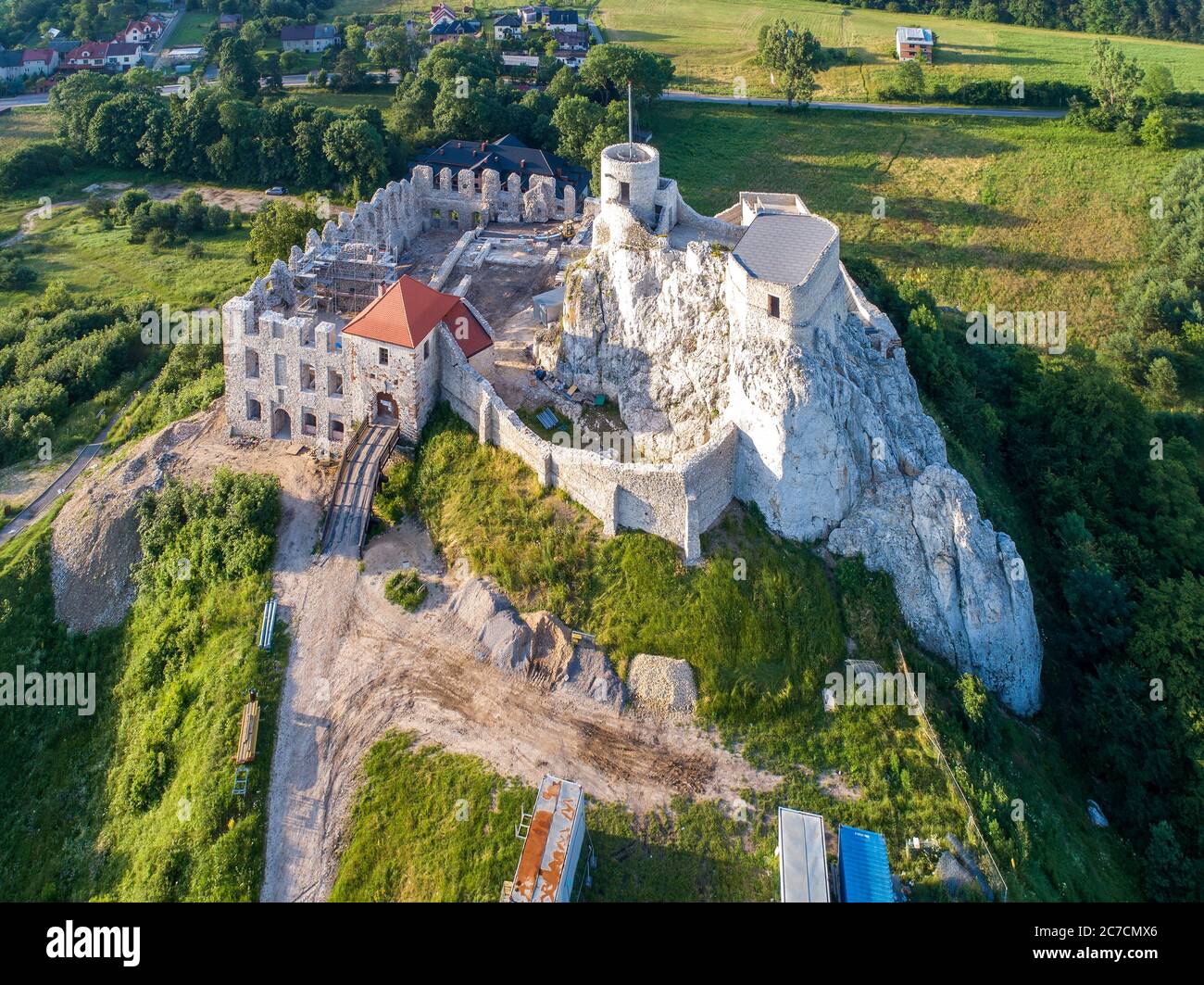 Rabsztyn, Poland. Ruins of medieval royal castle on the rock in Polish Jurassic Highland. Aerial view in sunrise light in summer. Renovation and arche Stock Photo