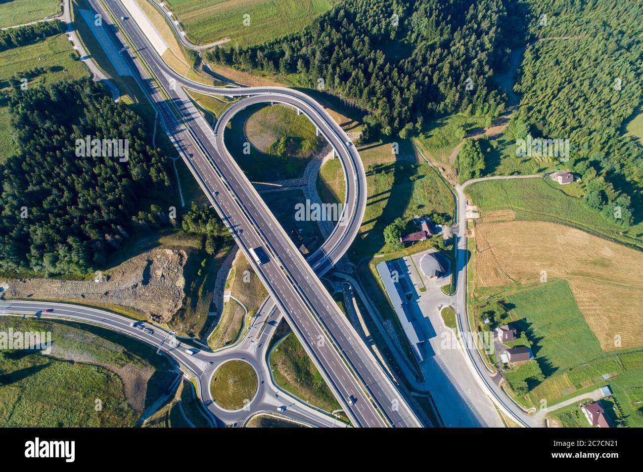 New motorway in Poland on national road no 7, E77, called Zakopianka.  Overpass crossroad/junction with a traffic circle, slip road and viaducts near Stock Photo