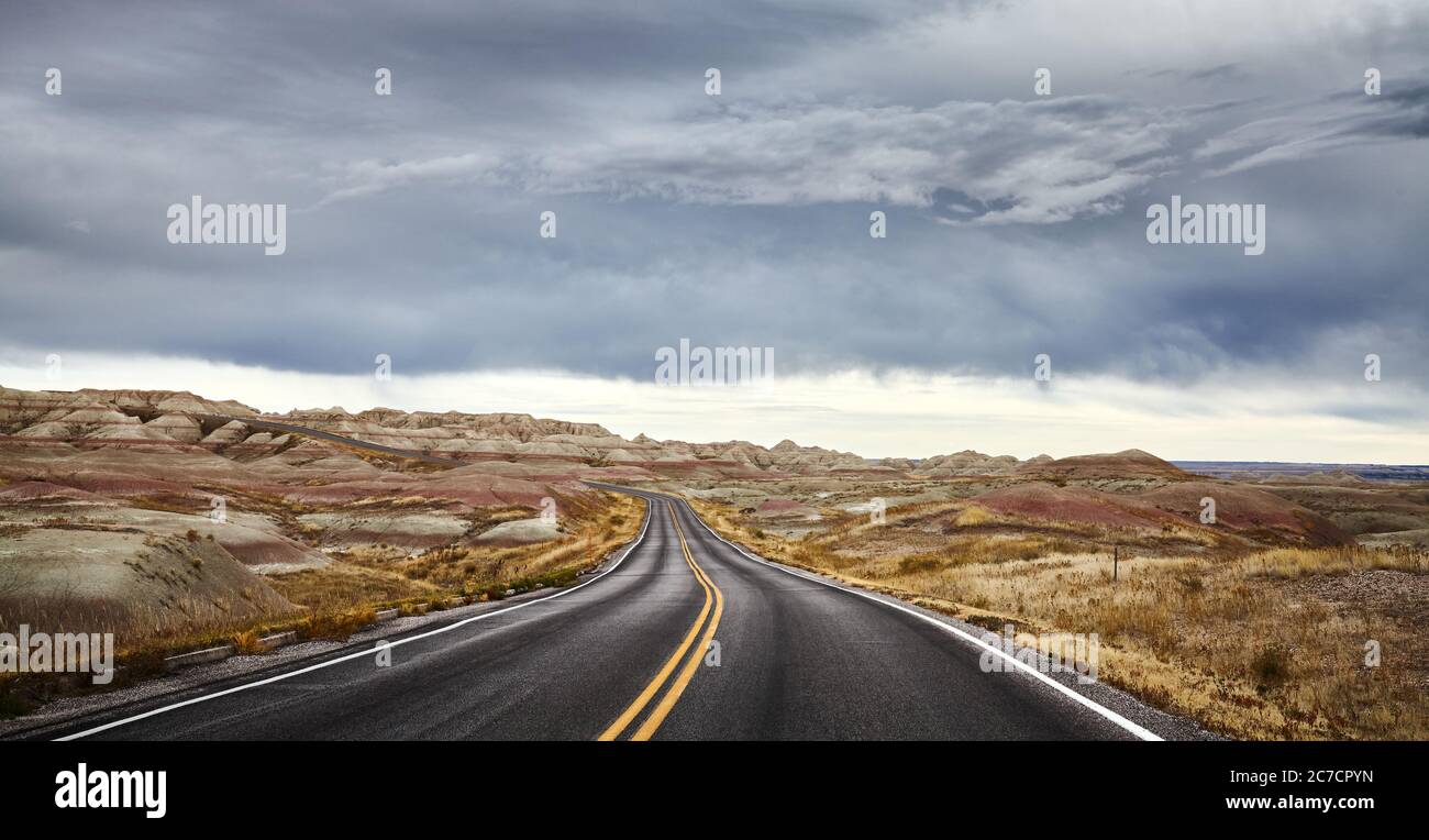 Stormy clouds over road in Badlands National Park, travel concept, South Dakota, USA. Stock Photo
