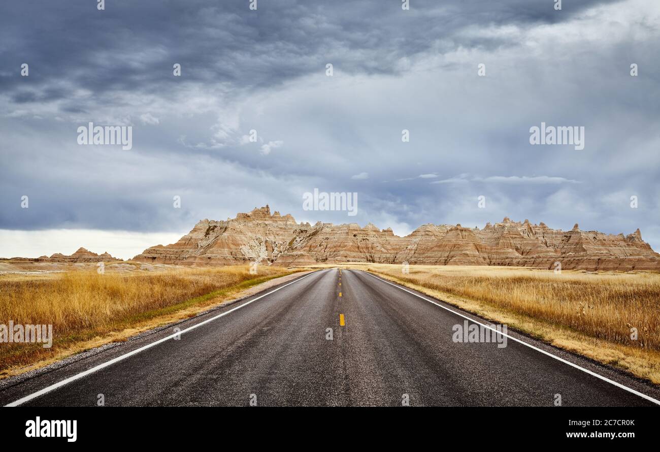 Stormy clouds over road in Badlands National Park, travel concept, USA. Stock Photo