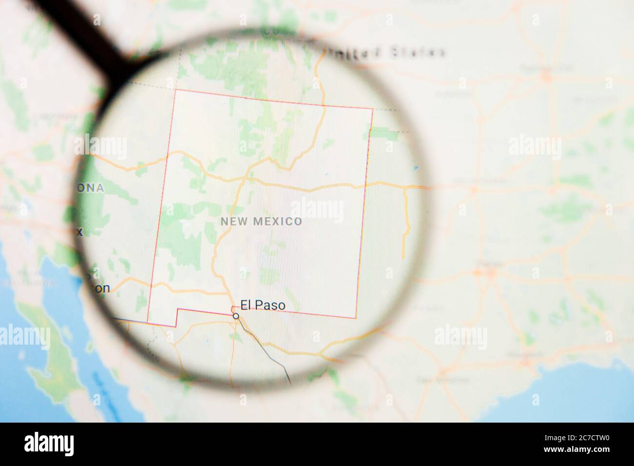 Los Angeles, California, USA - 15 March 2019: New Mexico, NM state of America visualization illustrative concept on display screen through magnifying Stock Photo
