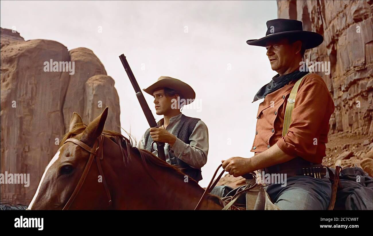 John Wayne and Jeffrey Hunter in the Searchers - Promotional Movie Picture Stock Photo