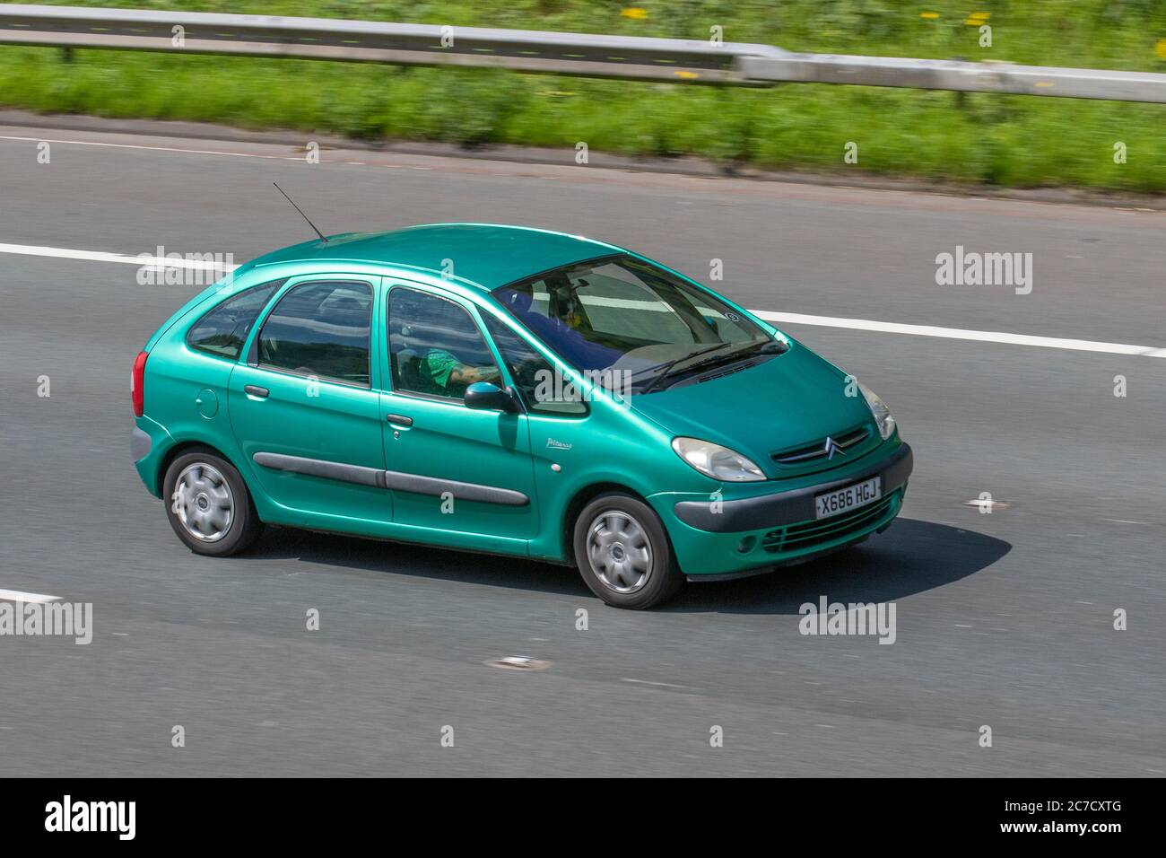 2000 green Citroën Xsara Picasso SX 8V; Vehicular traffic moving vehicles, cars driving vehicle on UK roads, motors, motoring on the M6 motorway highway network. Stock Photo