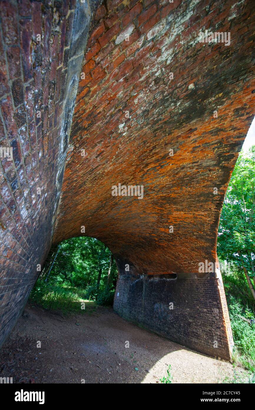 Redundant Victorian Railway bridge, red brick construction. arch architecture, transportation,rural, Great Central Railway Stock Photo