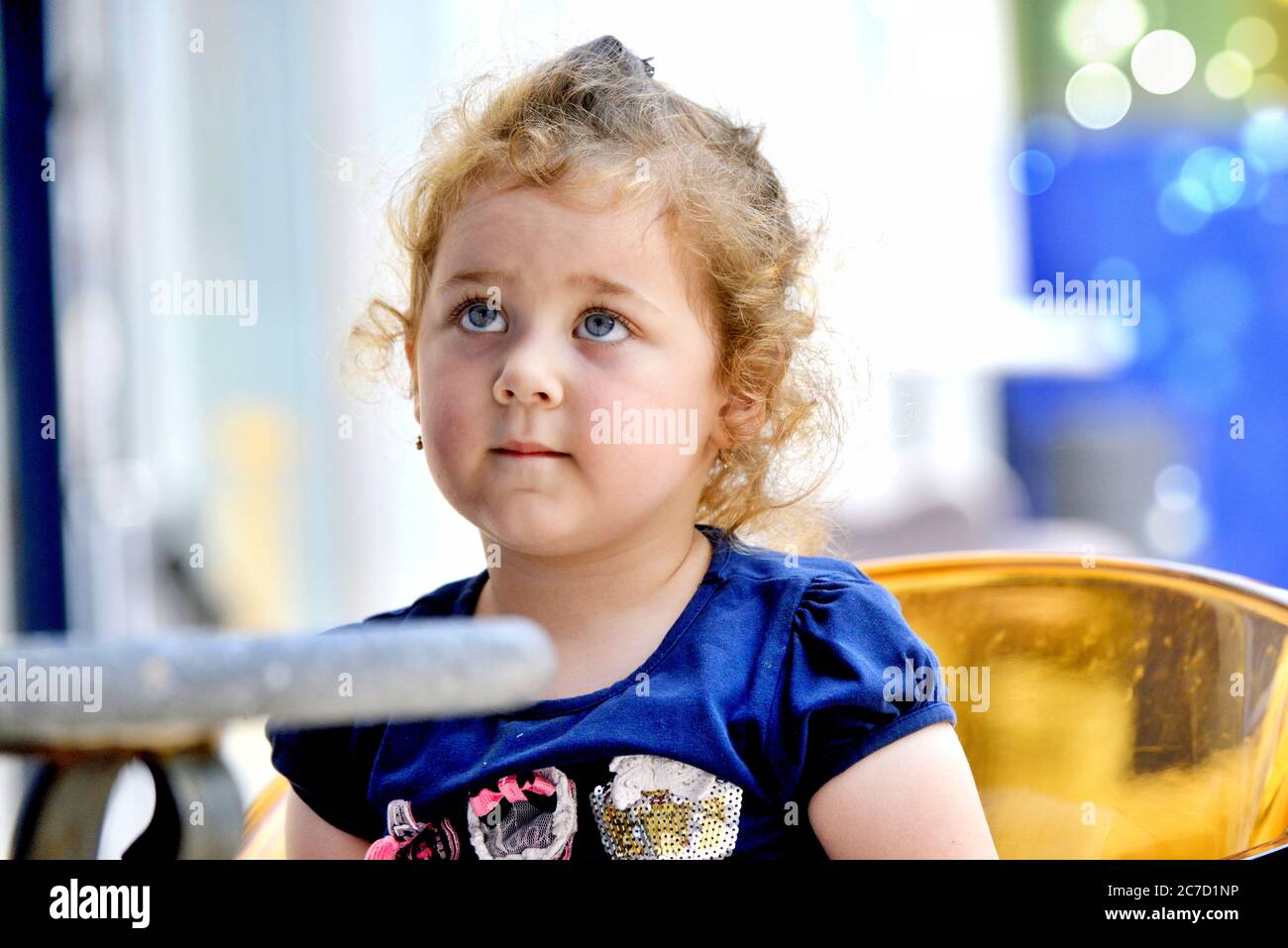 Cute little girl drinks orange juice using drinking straw .july 12 ,2020 resen, macedonia Stock Photo