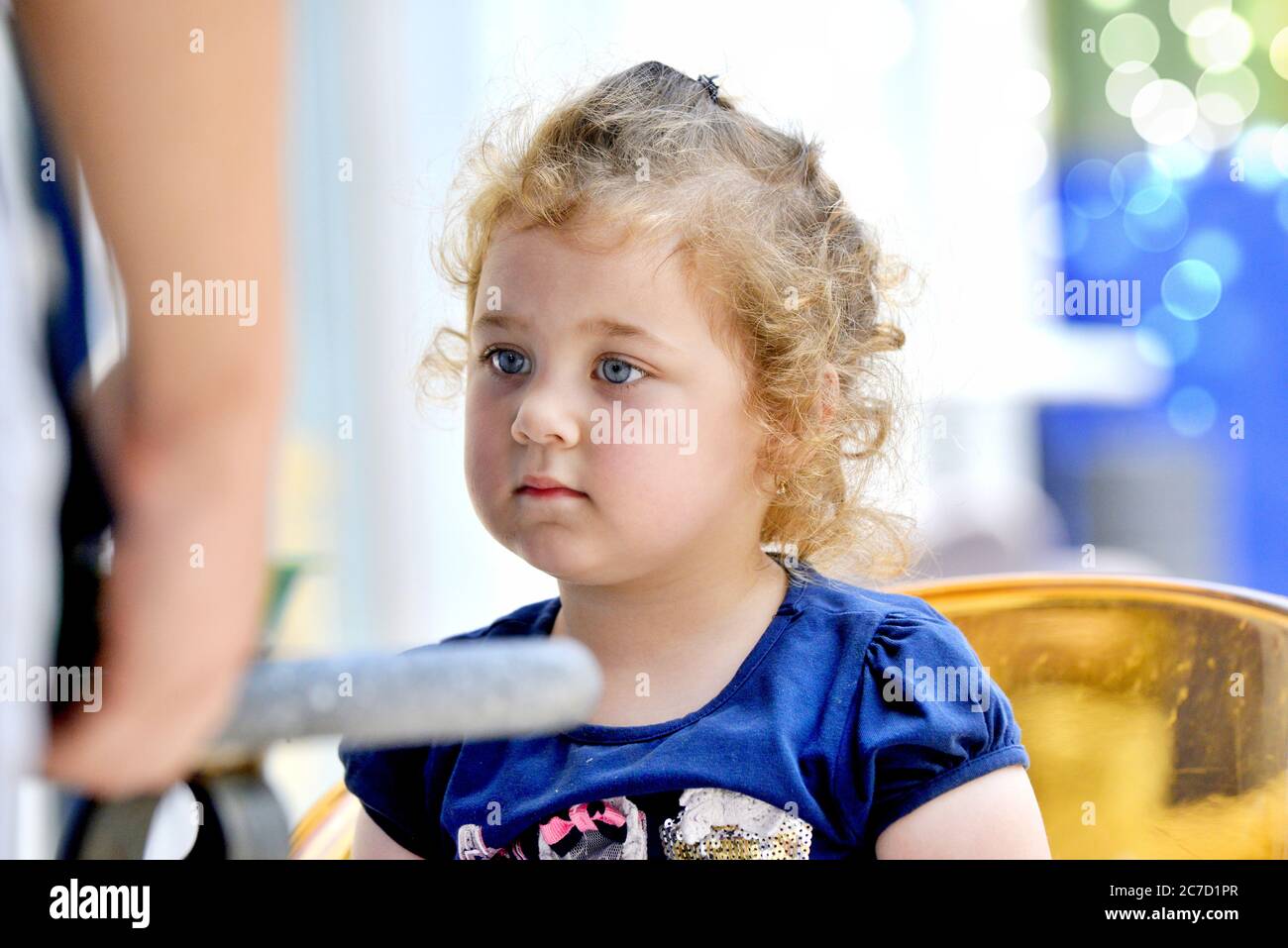 Cute little girl drinks orange juice using drinking straw .july 12 ,2020 resen, macedonia Stock Photo