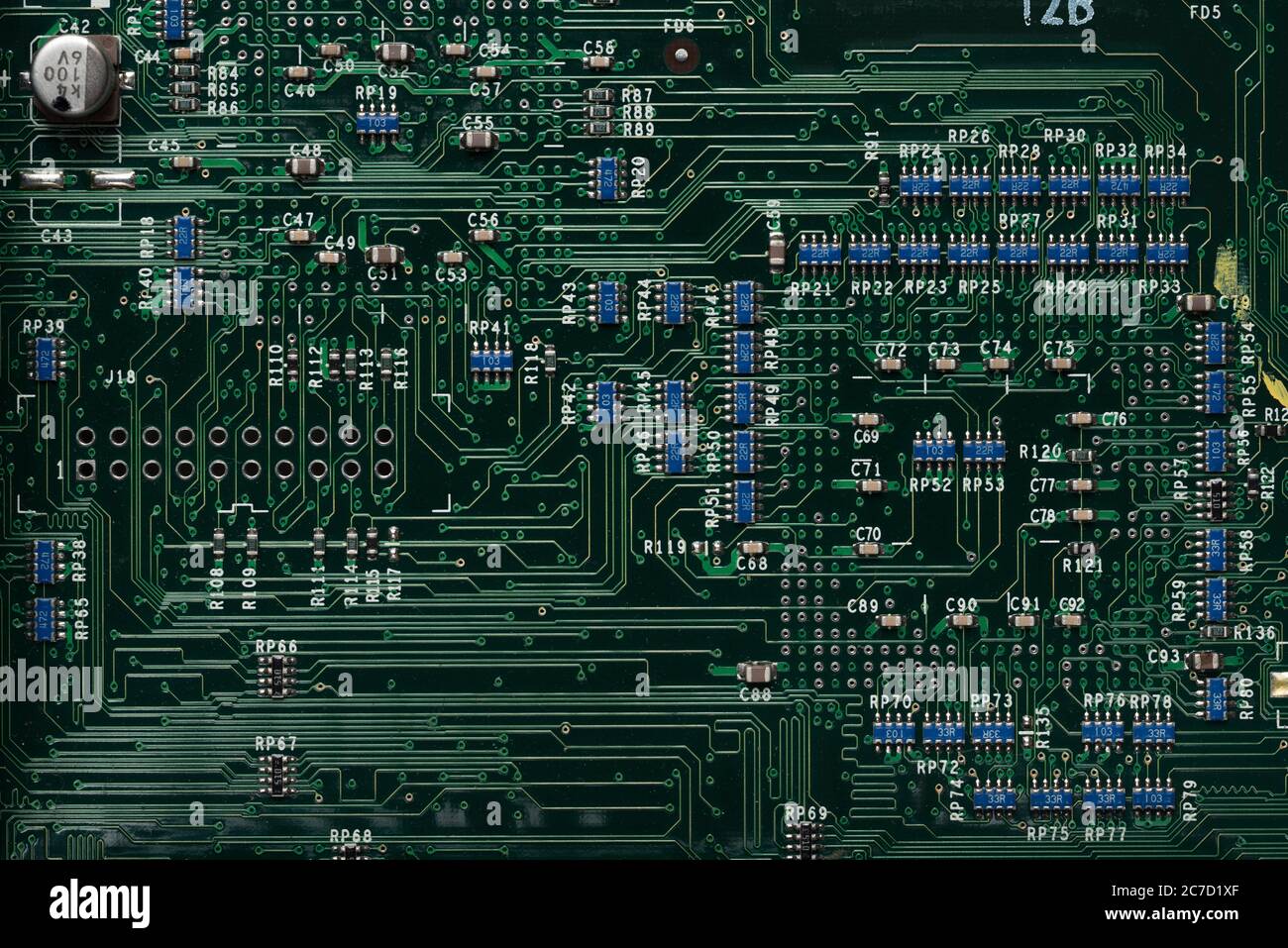 Neat printed circuit board from Mac computer with chip, diode, coil, resistors, capacitors like street layout in city arranged in rows and lines Stock Photo