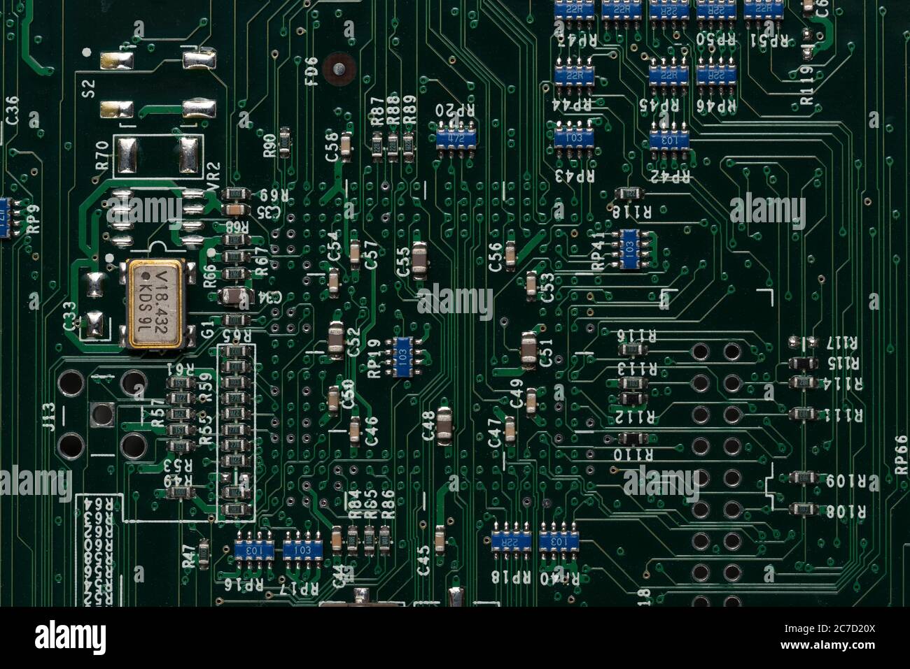 Neat printed circuit board from Mac computer with chip, diode, coil, resistors, capacitors like street layout in city arranged in rows and lines Stock Photo
