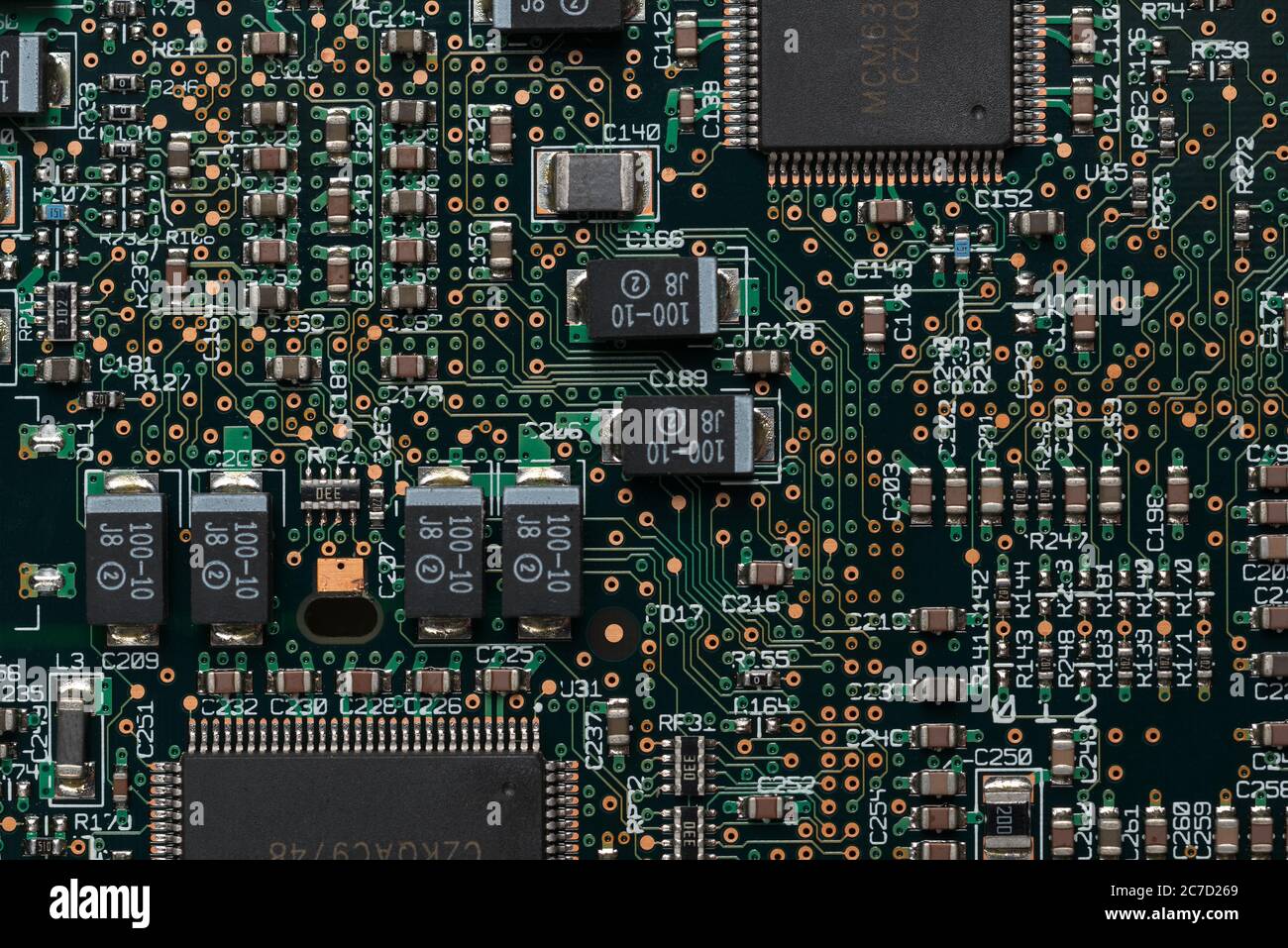 Neat printed circuit board from Mac computer with chip, diode, coil, resistors, capacitors like street layout in city arranged in rows and lines Stock Photo