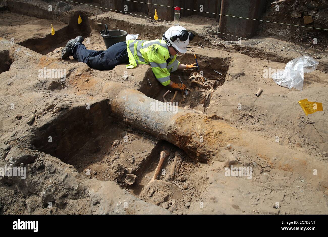 Archaeologist Clare McCabe from the Trams to Newhaven project excavating human remains, which could date back as far as 1300, from the graves of South Leith Parish Church whose medieval graveyard extends beneath the road surface of Constitution Street, Leith. Stock Photo