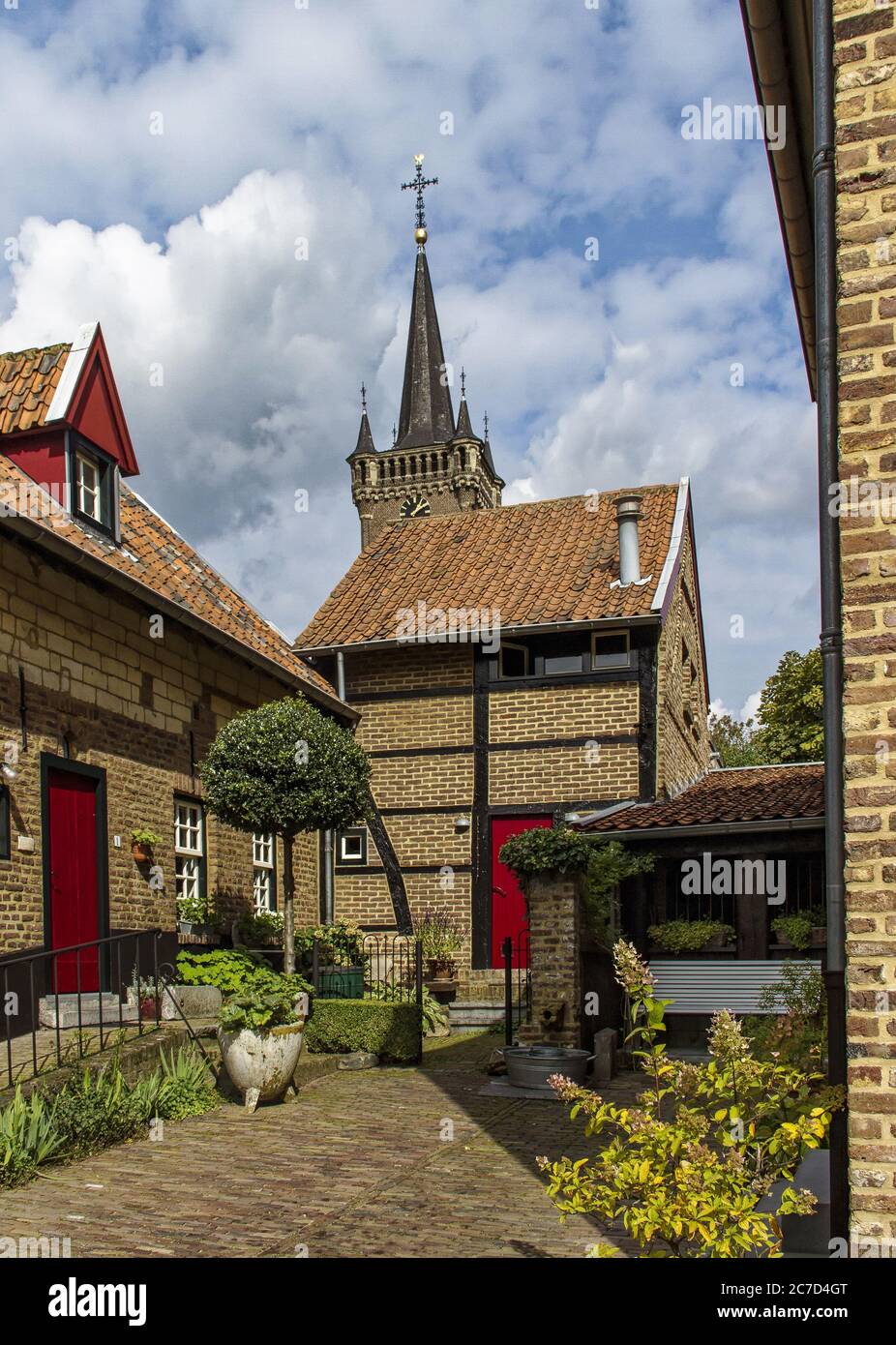 Low angle vertical shot of small brown houses and a church under the ...