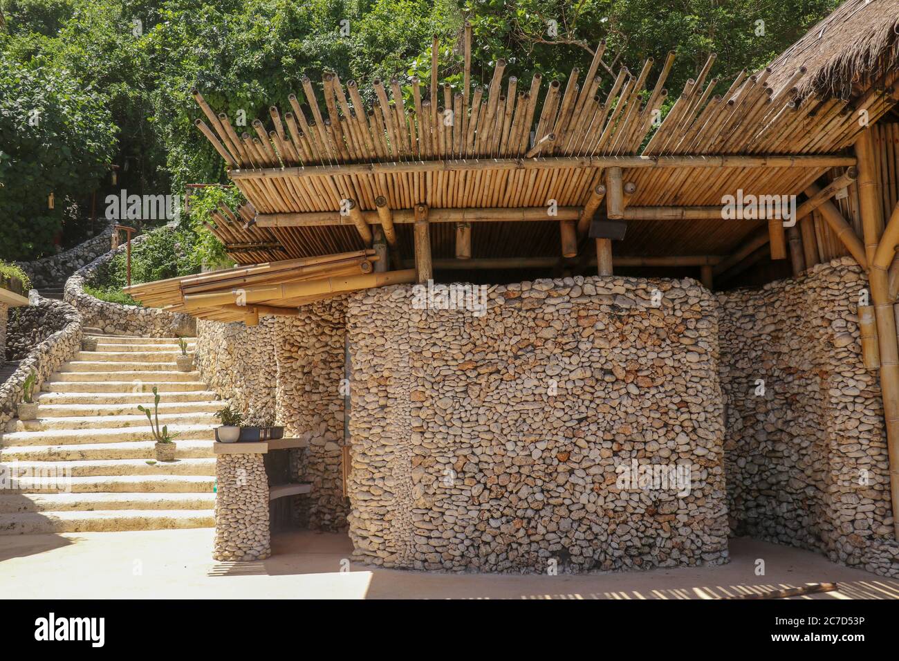 Reception area with reception desk in a beach club. Stone wall and bamboo  roof Stock Photo - Alamy