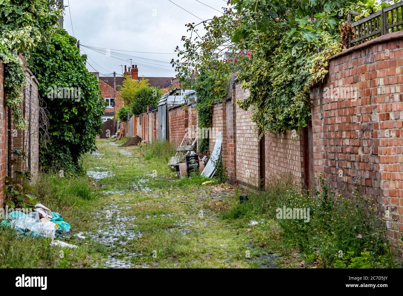 Unkept and dirty back alleyways between residenial properties in the Abington area of Northampton, England, UK. Stock Photo