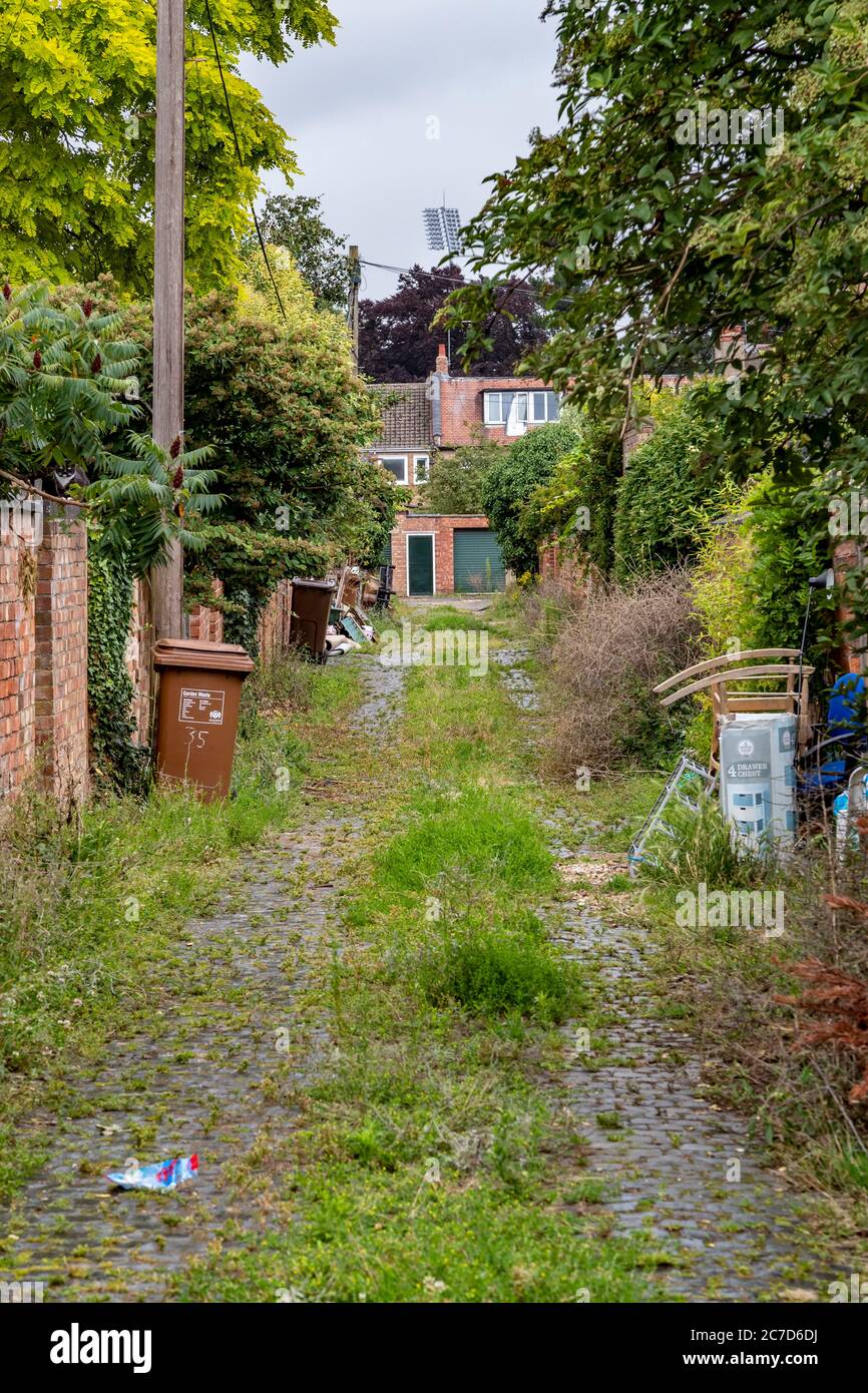 Unkept and dirty back alleyways between residenial properties in the Abington area of Northampton, England, UK. Stock Photo
