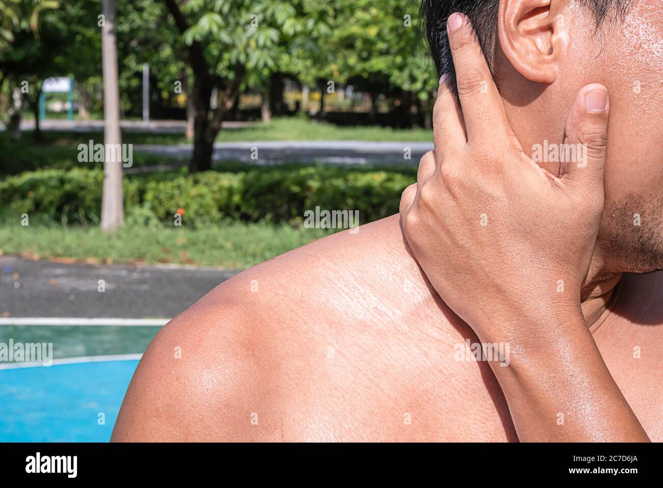 The hand grips the neck that inflammation from a sports injury Stock