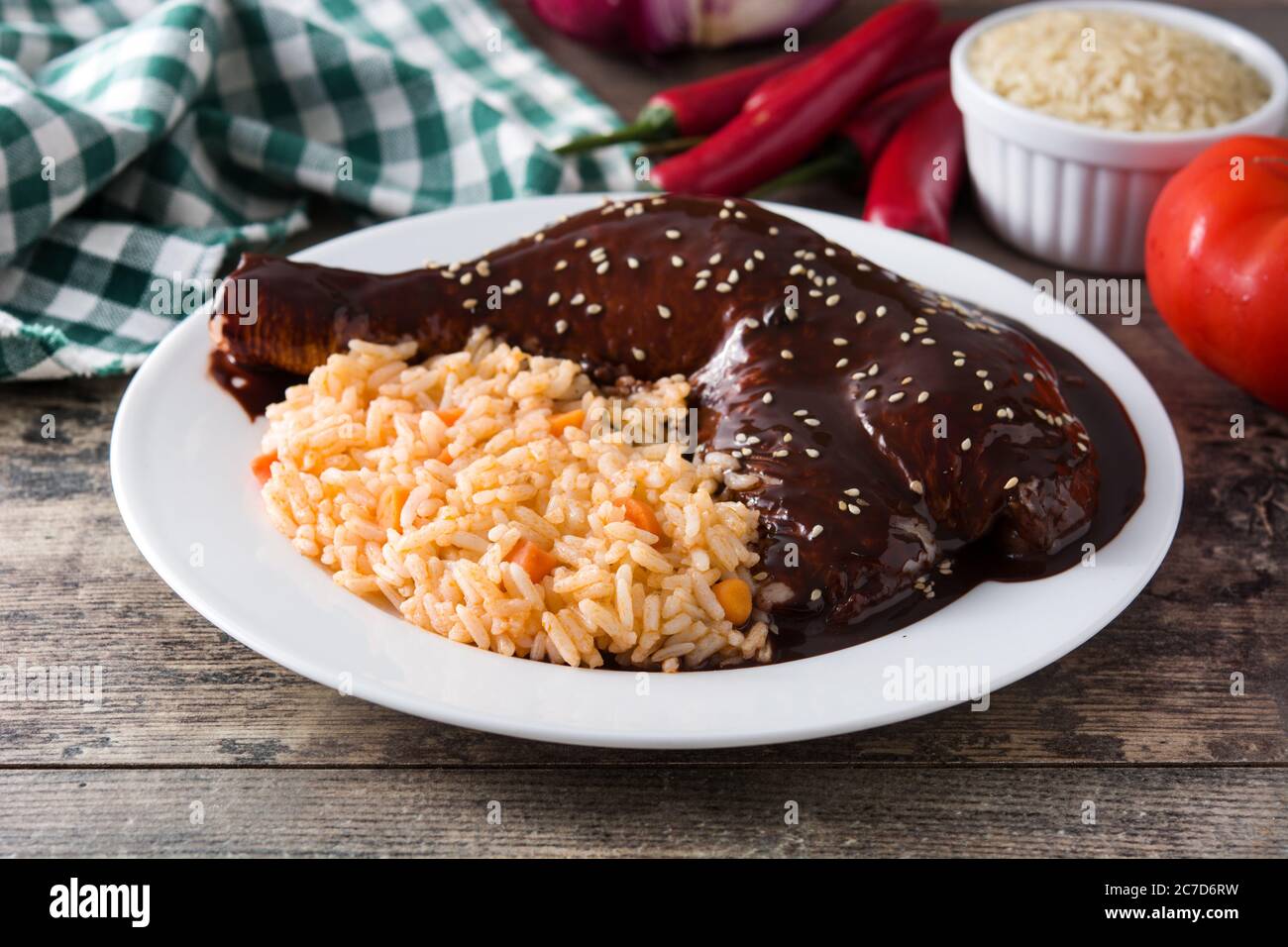 Traditional mole Poblano with rice in plate on wooden table Stock Photo