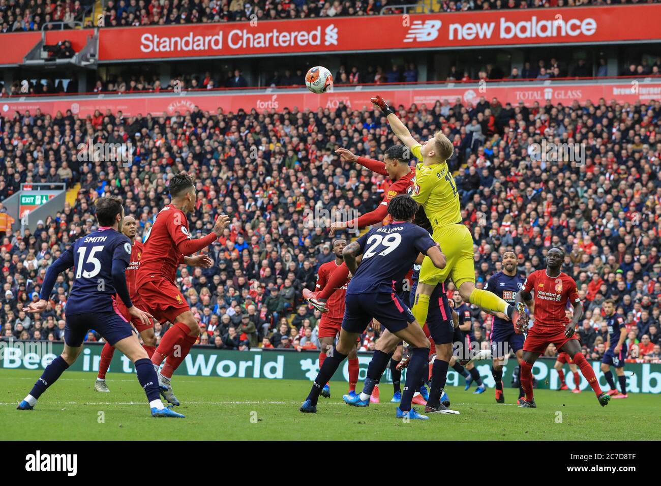 Bournemouth goalkeeper Aaron Ramsdale punches the ball out from a Liverpool  free-kick while under pressure from Virgil van Dijk (4) of Liverpool Stock  Photo - Alamy