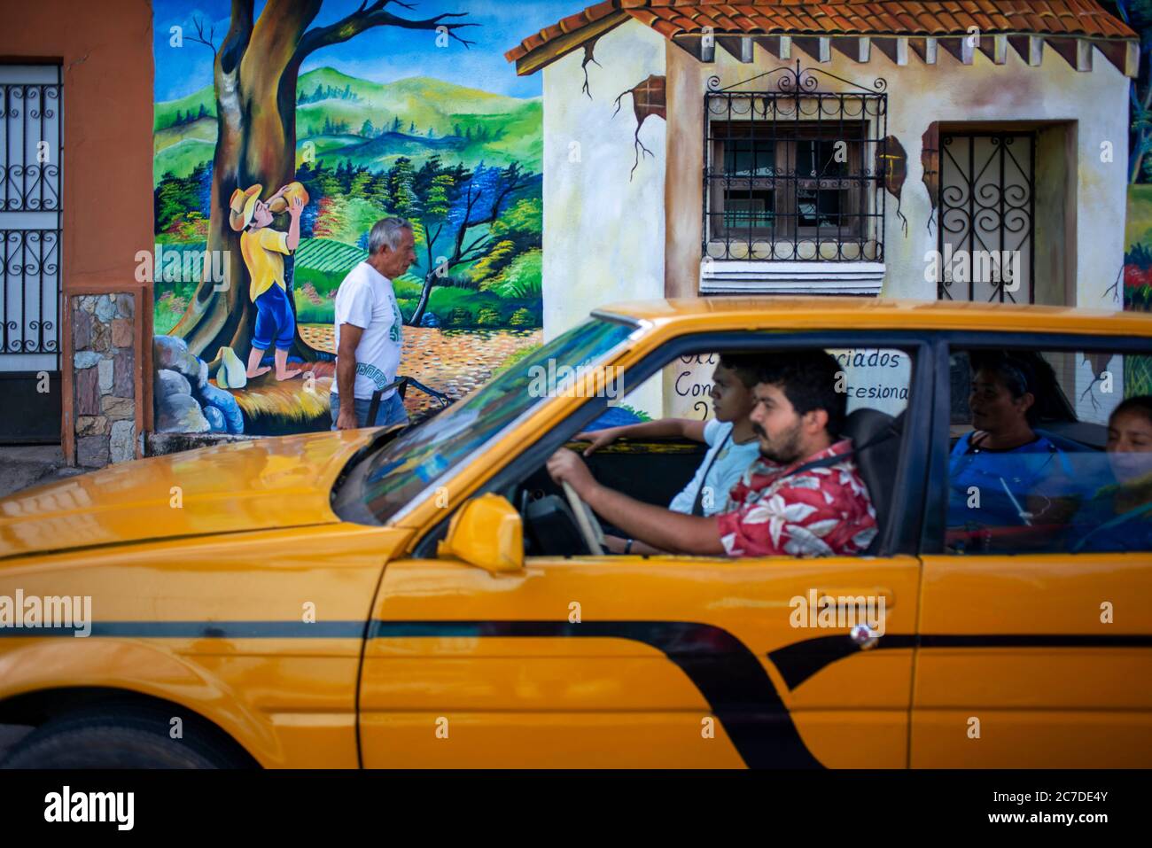 Taxi and Wall street art graffiti in Salcoatitan Sonsonate El Salvador Central America. Ruta De Las Flores, Department Of Sonsonate. Stock Photo