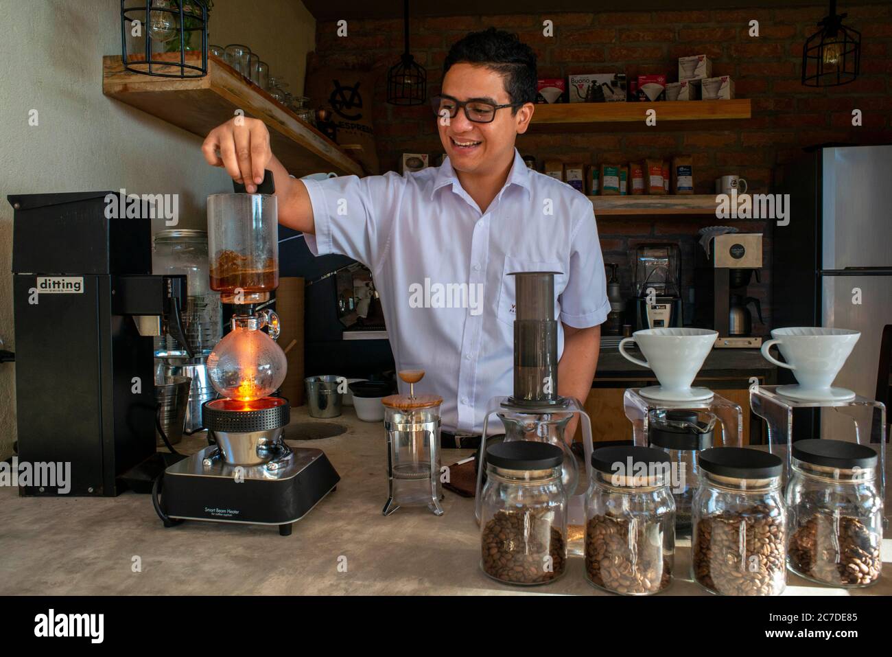 Viva Espresso Tasting coffe in the siphon coffee maker. El Carmen State Organic Coffee brand plantations and distribution in Concepción de Ataco El Sa Stock Photo
