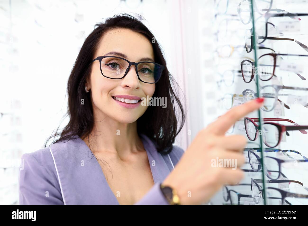 Manager consultant points to showcase with optics Stock Photo Alamy
