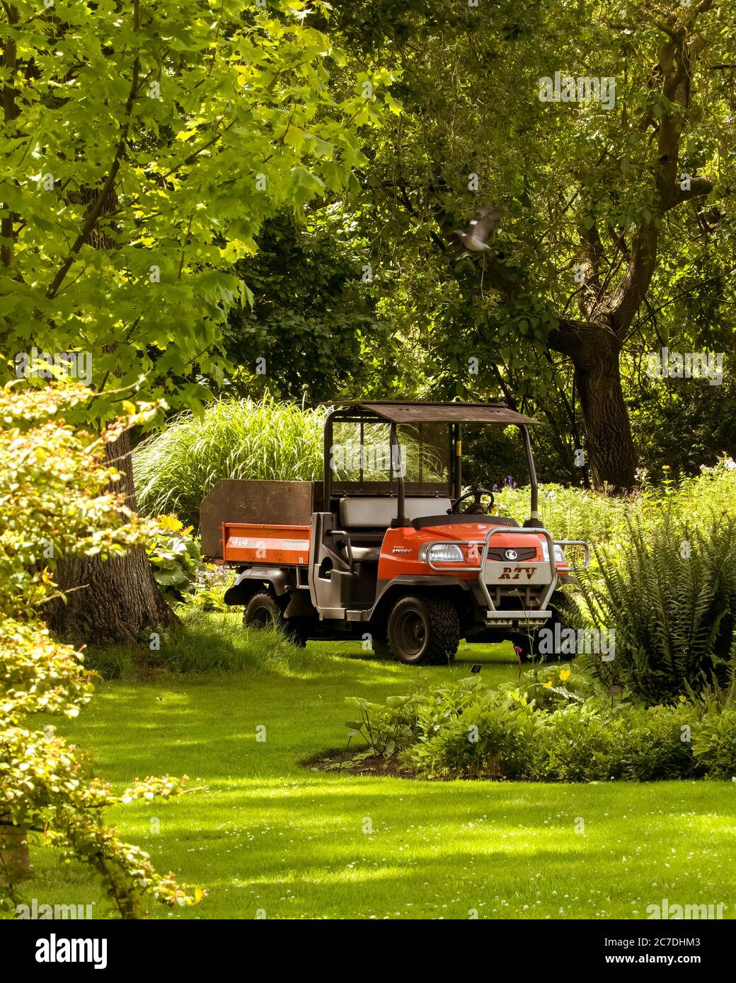 Kubota 4X4 utility vehicle in beautiful English garden with no people in view. July 19th 2020 - Diss, Norfolk, UK Stock Photo