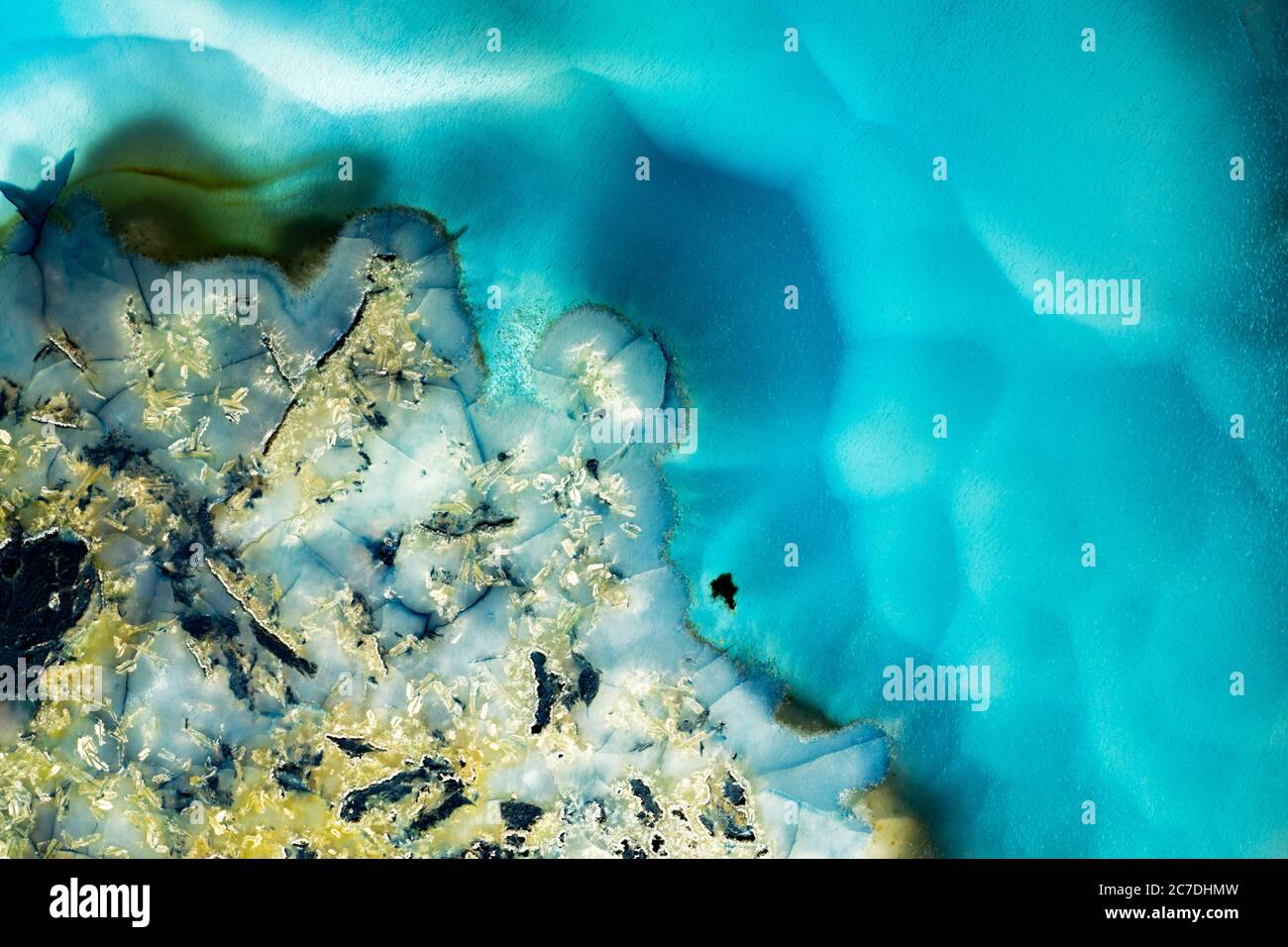 Agate rock slice with colorful turquoise blue and white mineral textures. Stock Photo