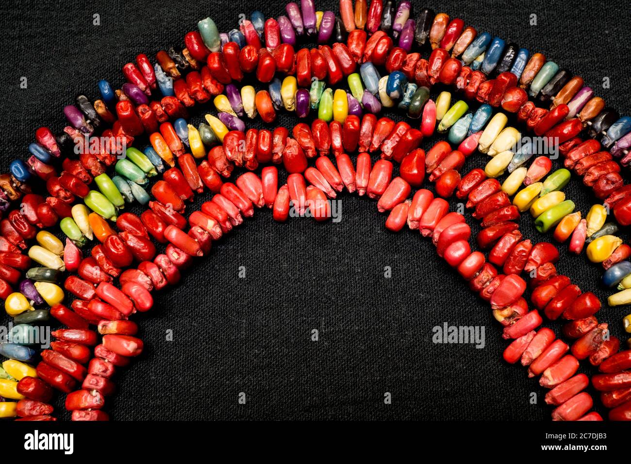 Colorful candy pieces shaped into a rainbow design on a black background. Stock Photo