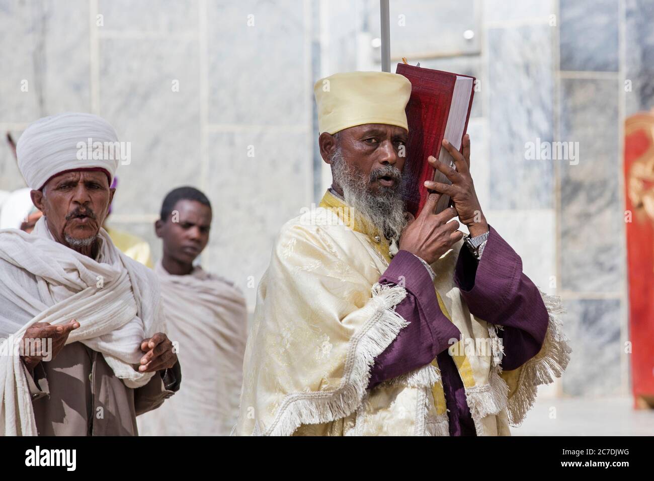 Orthodox priest holding bible at the Church of Our Lady Mary of Zion, Axum / Aksum, Tigray Region, Ethiopia, Africa Stock Photo