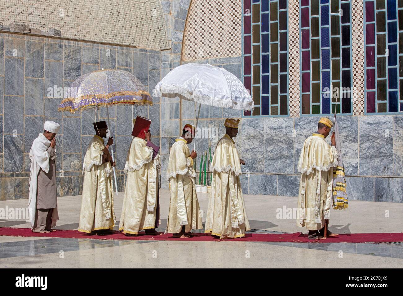 Orthodox priests with parasols during ceremony walking around the Church of Our Lady Mary of Zion, Axum / Aksum, Tigray Region, Ethiopia, Africa Stock Photo