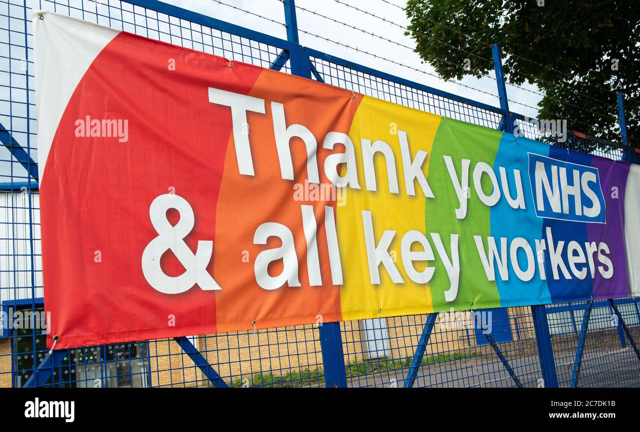Rainbow banner attached to a fence, in gratitude to all NHS medical staff and keyworkers who are working during the UK Coronavirus pandemic crisis. Stock Photo