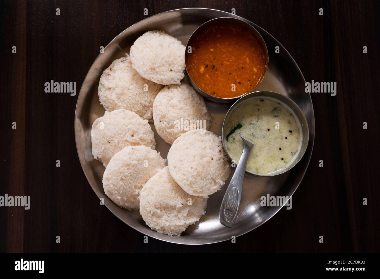 a top view of south karnataka homemade rave idly, sambar & chutney isolated on wooden table Stock Photo