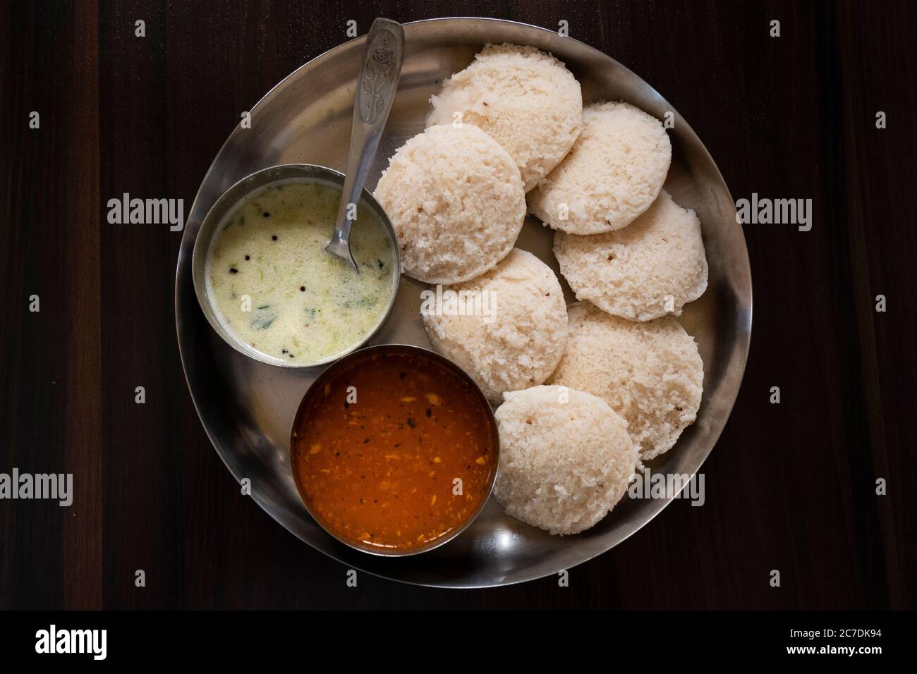 a top view of south karnataka homemade rave idly, sambar & chutney isolated on wooden table Stock Photo