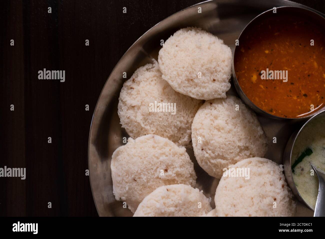 a closeup view of south karnataka homemade rave idly, sambar & chutney isolated on wooden table Stock Photo