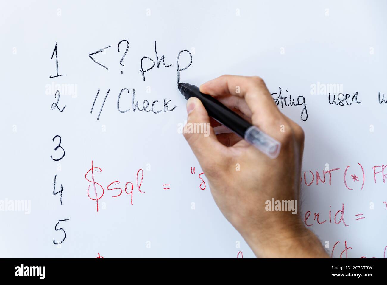 programmer education and web development - hand with marker writing php programming code on whiteboard Stock Photo