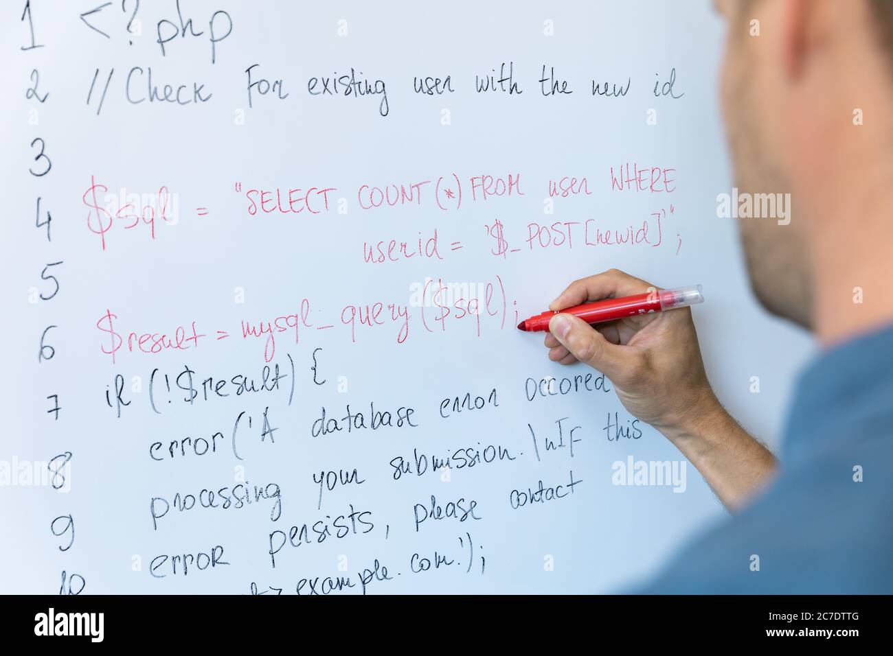 data safety and programming education concept - man writing php code on whiteboard Stock Photo