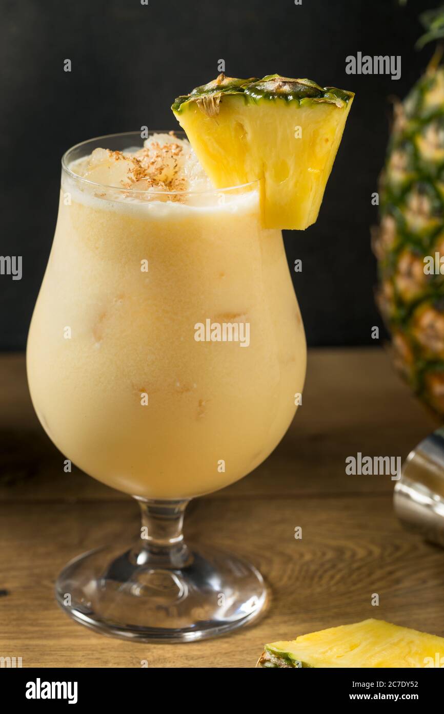 Boozy PIneapple Painkiller Cocktail with Coconut Cream and Nutmeg Stock Photo