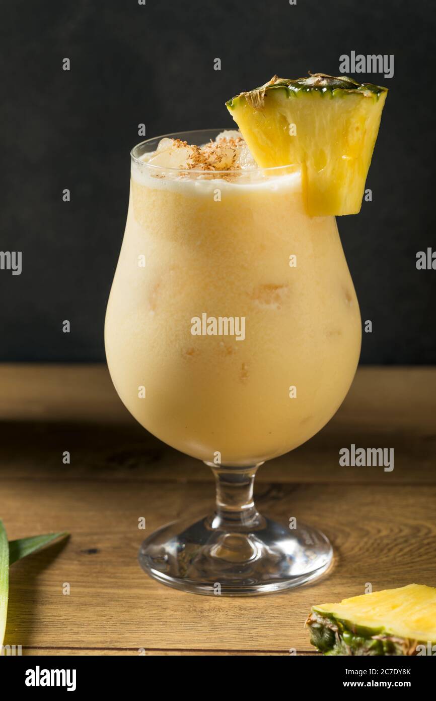 Boozy PIneapple Painkiller Cocktail with Coconut Cream and Nutmeg Stock Photo