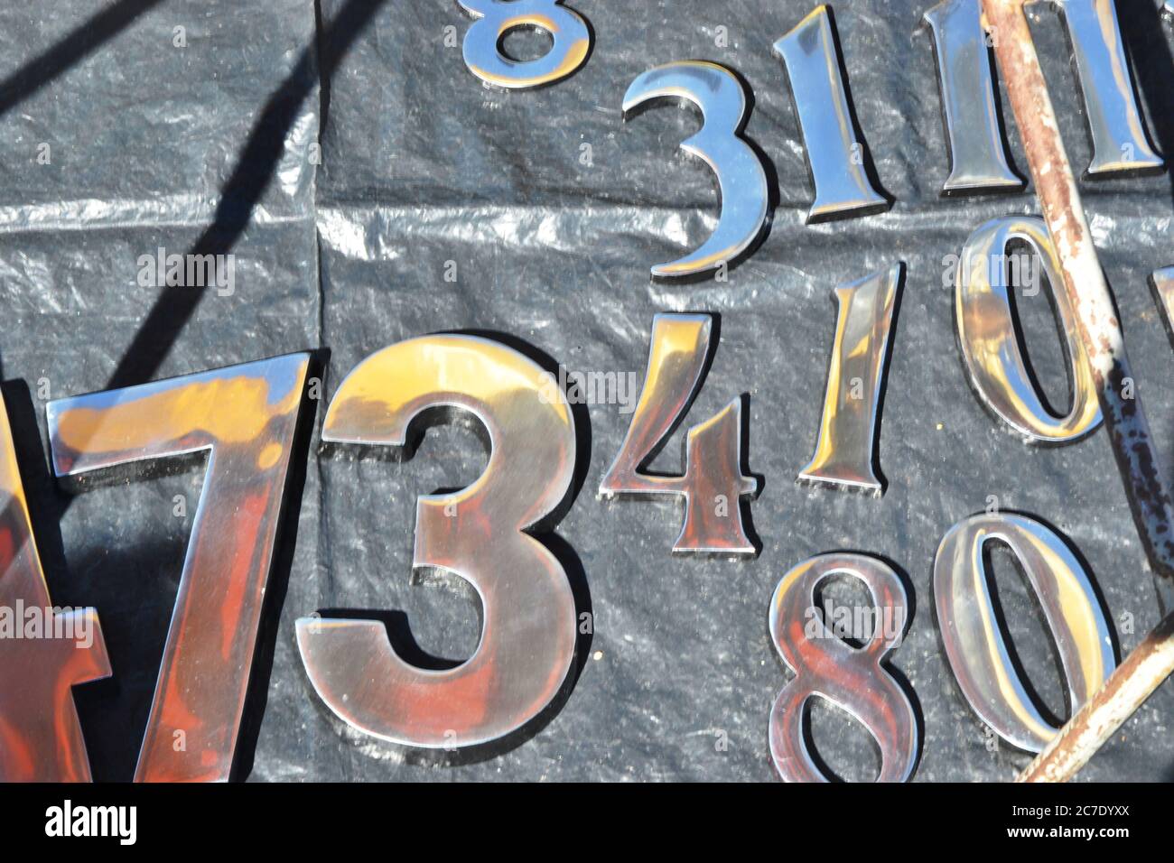 Metal numbers to be placed on the facades of houses, for sale at a street fair in the interior of Brazil, South America Stock Photo