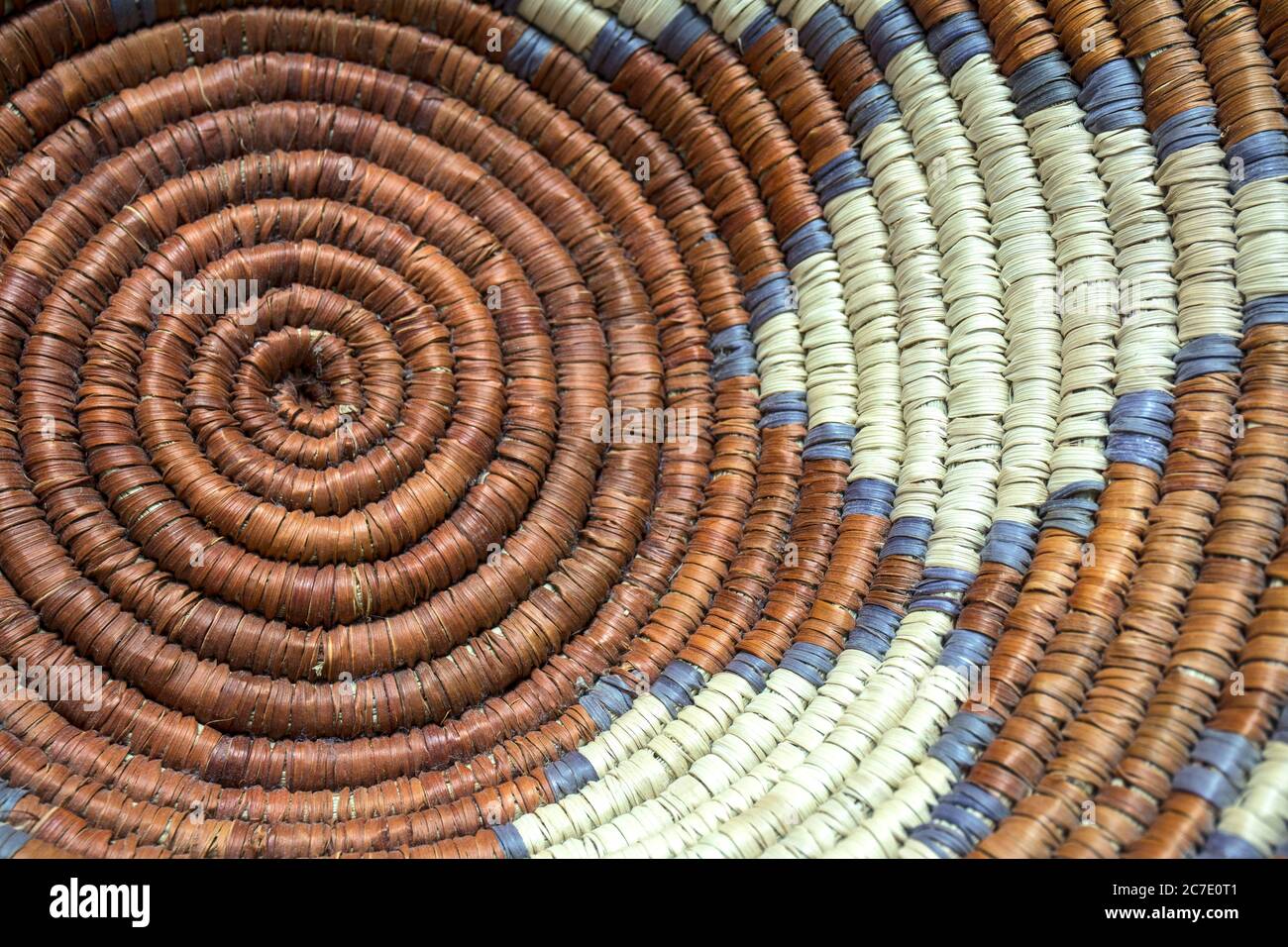 Native American Indian woven basket with rust and tan colors and a star pattern. Stock Photo