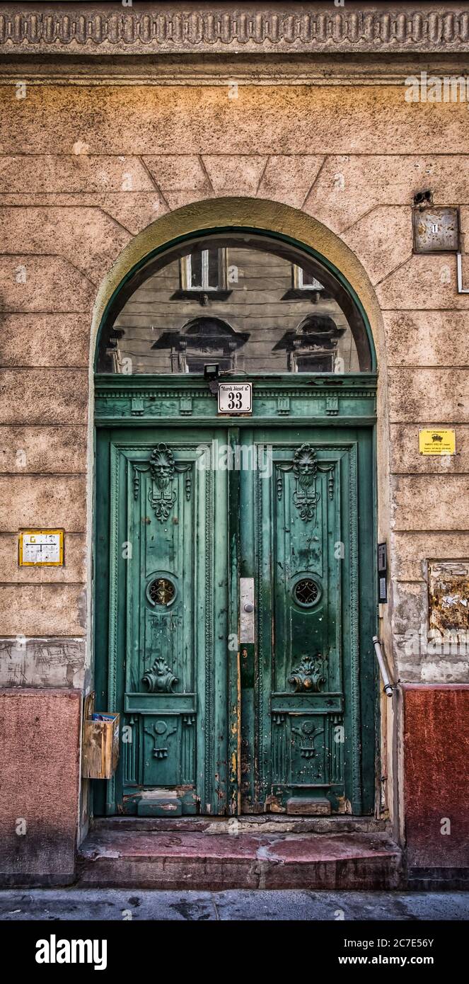 Budapest, Hungary, March 2020, close up of a green carved wooden entrance door in Marek Jozsef street Stock Photo